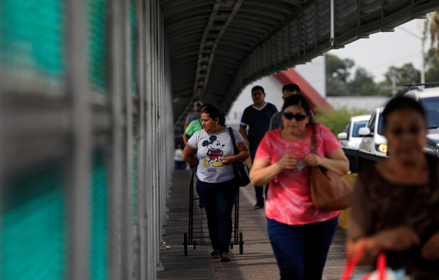 People cross the the Brownsville-Matamoros International Bridge on the U.S.-Mexico border in Matamoros, Tamaulipas 