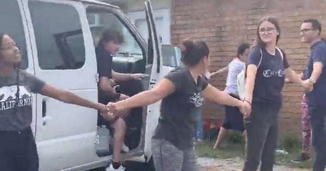 Neighbors form human chain to protect man from ICE - CBS News