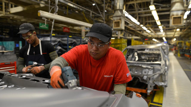 Line workers install the trunk on the flex line at Nissan Motor Co's automobile manufacturing plant in Smyrna Tennessee 