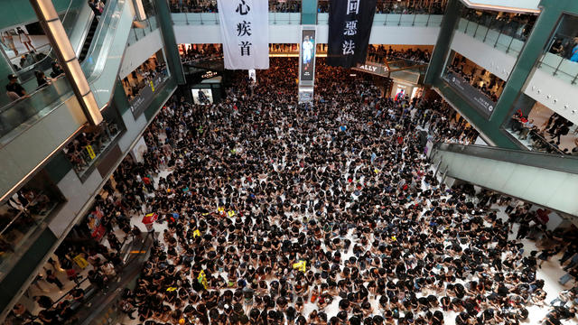 Demonstrators attend a rally to support the city-wide strike and to call for democratic reforms at New Town Plaza shopping mall in Hong Kong 