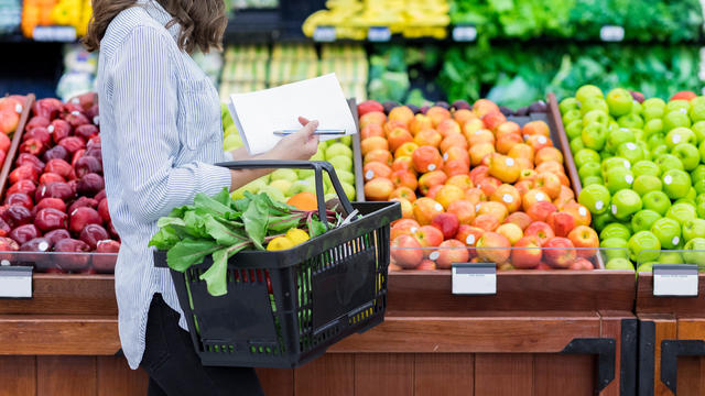 Unrecognizable woman shops for produce in supermarket 