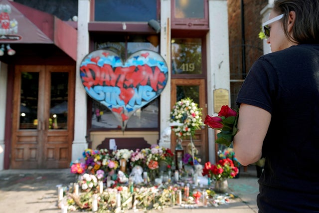 FILE PHOTO: A Oregon District resident stands at a memorial for those killed during Sunday morning's a mass shooting in Dayton