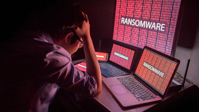 Young Asian male frustrated by ransomware cyber attack 