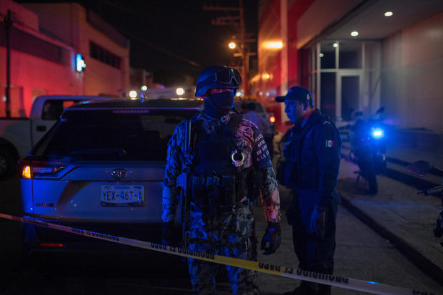 Federal forces keep watch at a crime scene following a deadly attack at a bar by unknown assailants in Coatzacoalcos 