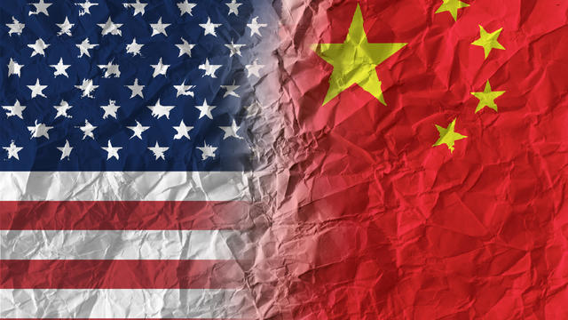 American and Chinese flags on crumpled paper, diplomatic crisis 