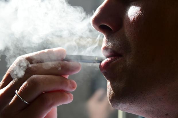 exhaling smoke from an electronic cigarette vaping teens vape pens nicotine 