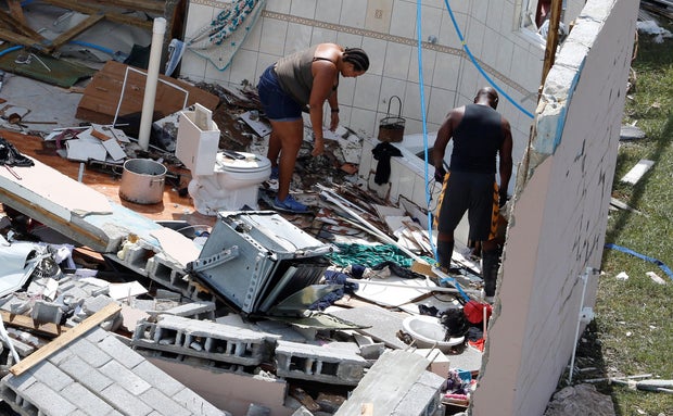 Residents look through debris after hurricane Dorian hit the Grand Bahama Island in the Bahamas