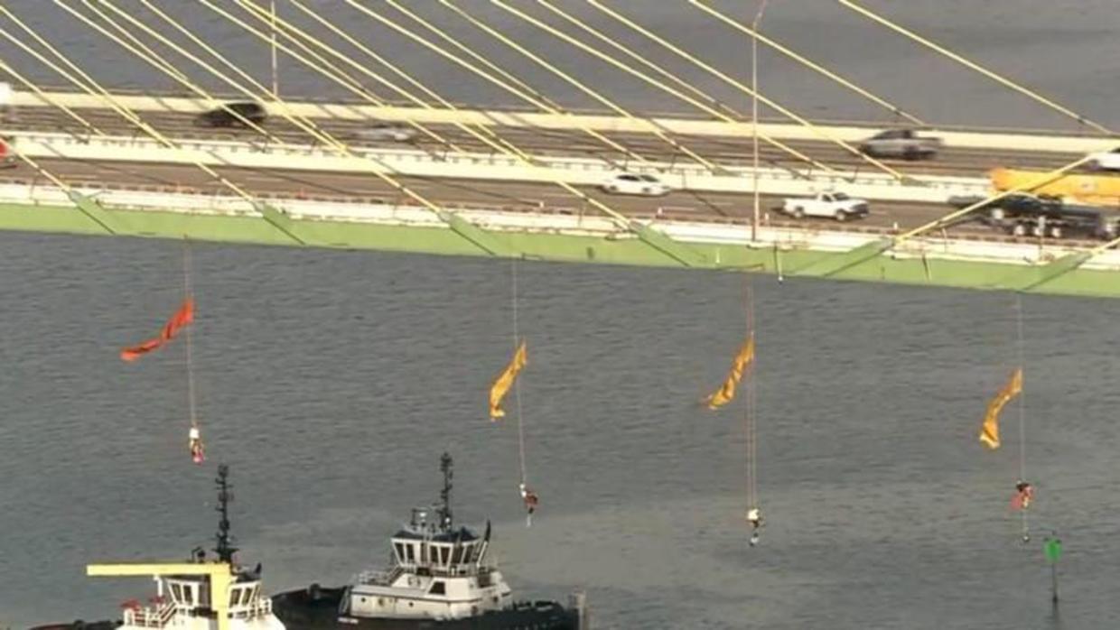 Greenpeace activists protest by hanging from Fred Hartman Bridge in Houston today CBS News