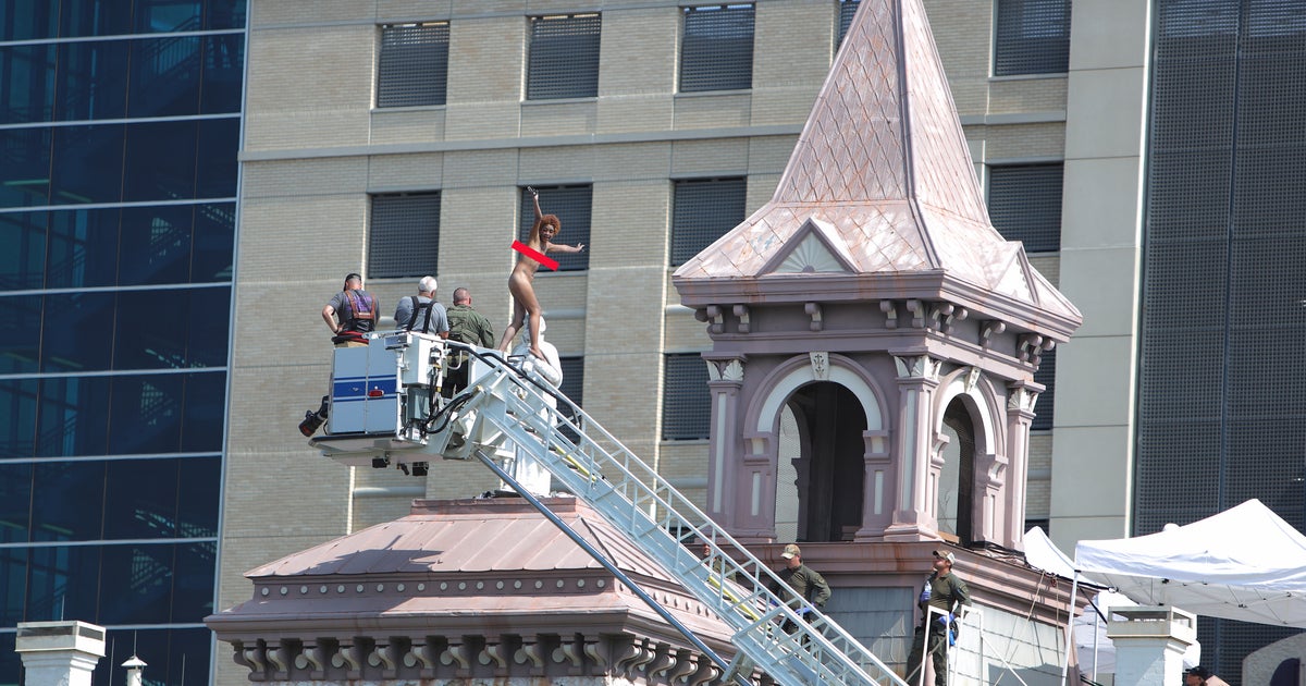 Naked Woman Climbs Atop Saint Patrick Cathedral Statue, Sits, Stands
