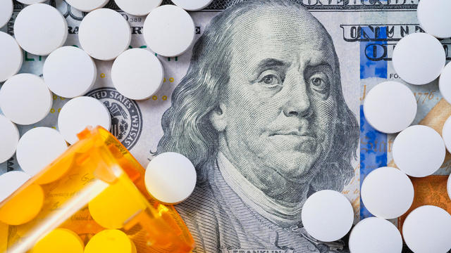 White pills on US currency 