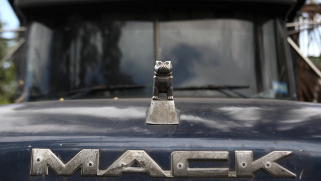 The logo of Mack Trucks is seen on a truck in a yard in Mejicanos 