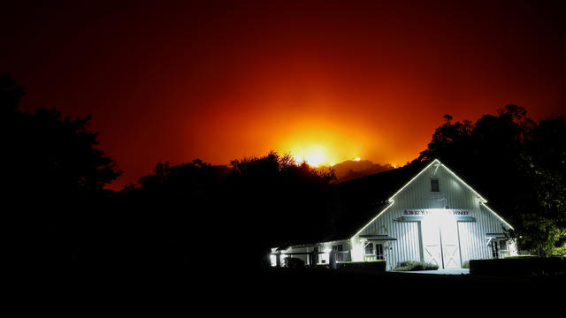 A firefighter gives orders as he battles the wind-driven Kincade Fire in Windsor, California, October 27, 2019. 