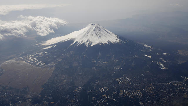 Japan's Mount Fuji is seen covered with snow from an airplane 