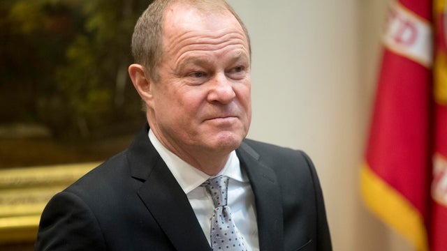 Shoppers carry bags from a Gap store as they walk along Fifth Avenue in the Manhattan borough of New York 