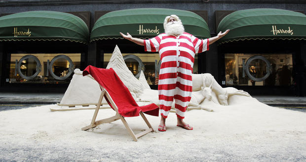 Man dressed as Father Christmas poses for photographers outside Harrods 