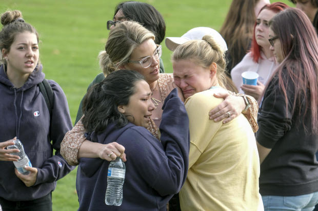 Students are comforted as they wait to be reunited with their parents following a shooting at Saugus High School November 14, 2019, in Santa Clarita, California. 