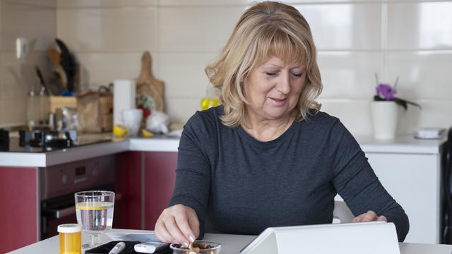 Senior diabetic woman preparing a breakfast  at home 