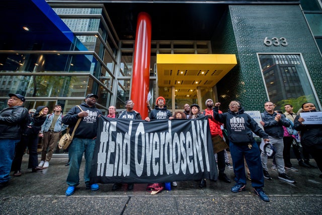 Protesters using a banner blocking access to the building in 