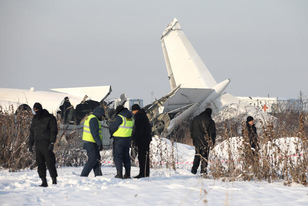 Emergency and security personnel are seen at the site of a plane crash near Almaty 