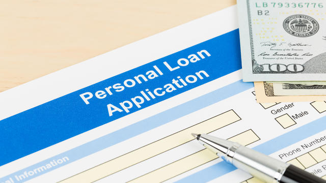 Personal loan application form with dollar money banknote, and pen 