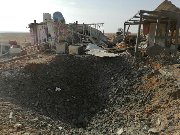 A hole left after an air strike is seen at headquarters of Kataib Hezbollah militia group in Qaim 