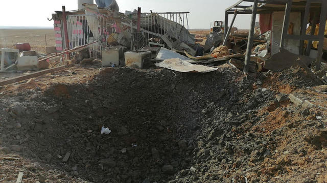 A hole left after an air strike is seen at headquarters of Kataib Hezbollah militia group in Qaim 