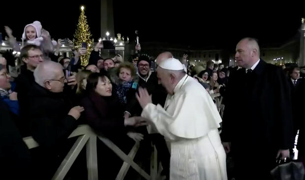 Pope Francis slaps the hand of a woman who grabbed him, at Saint Peter's Square at the Vatican 