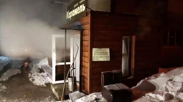Steam comes out from a door of the Mini Hotel Caramel after a hot water pipe exploded in the night and flooded a basement hotel room with boiling water, in Perm 