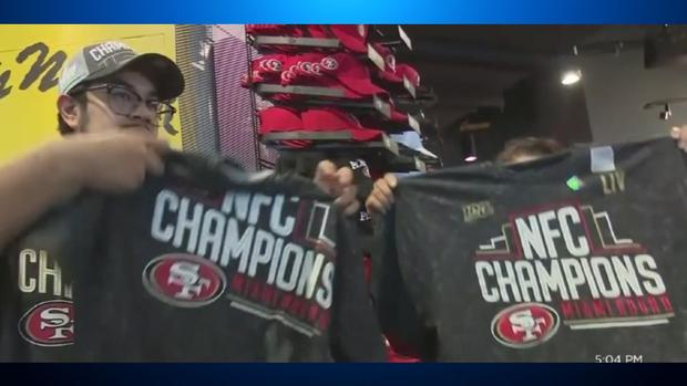 Fans Hold 49ers NFC Championship Shirts (CBS) 