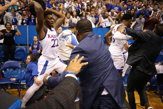 Silvio De Sousa, No. 22 of the Kansas Jayhawks, picks up a chair during a brawl as the game against the Kansas State Wildcats ends at Allen Fieldhouse on January 21, 2020, in Lawrence, Kansas. 