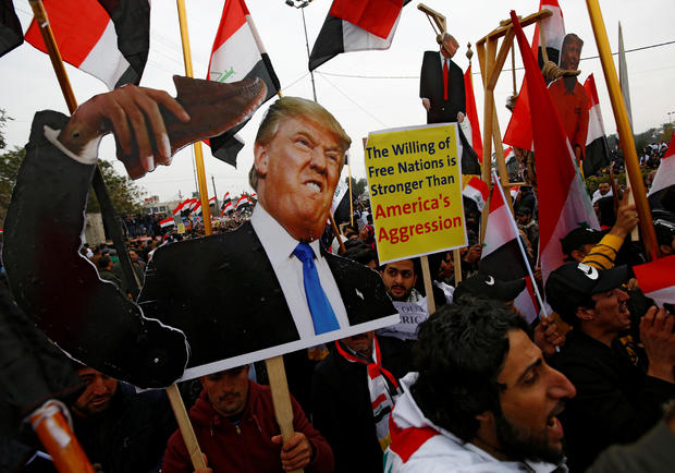 Supporters of Iraqi Shi'ite cleric Moqtada al-Sadr carry placards depicting U.S. President Donald Trump at a protest against what they say is U.S. presence and violations in Iraq, duri in Baghdad 