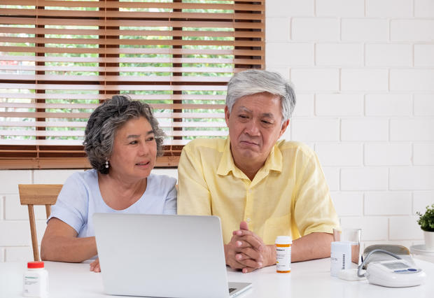 Asian Couple Seniors Use Laptop Video Conference With Doctor Abo 