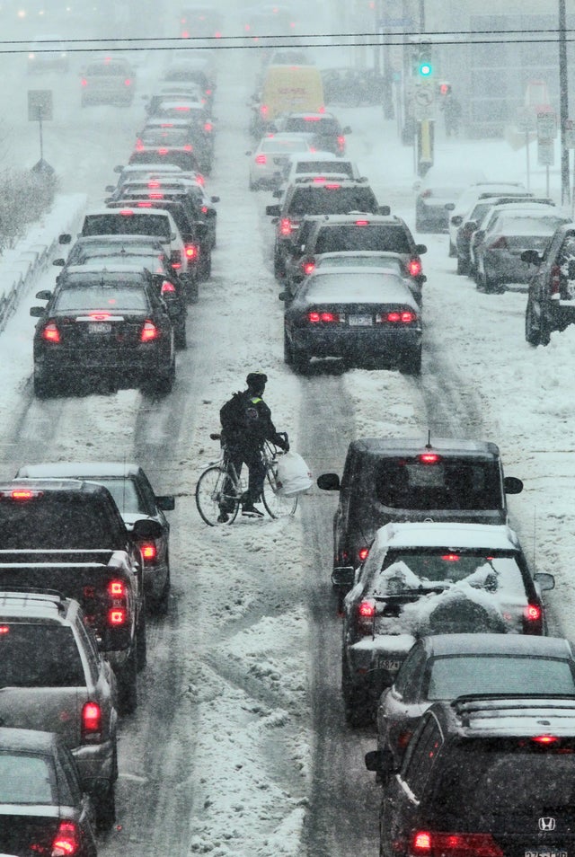 Snow conditions downtown Minneapolis. A lone bicyclist looked a little lost in the rush hour traffic of downtown Minneapolis. (MARLIN LEVISON/STARTRIBUNE(mlevison@startribune.com (cq )