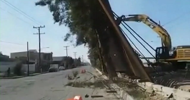 Part of U.S. border wall falls over into Mexico CBS News