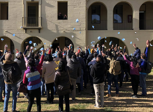 People evacuated from the epicenter of the coronavirus outbreak in China celebrate the end of their quarantine at March Air Reserve Base in Moreno Valley, California, on February 11, 2020. 