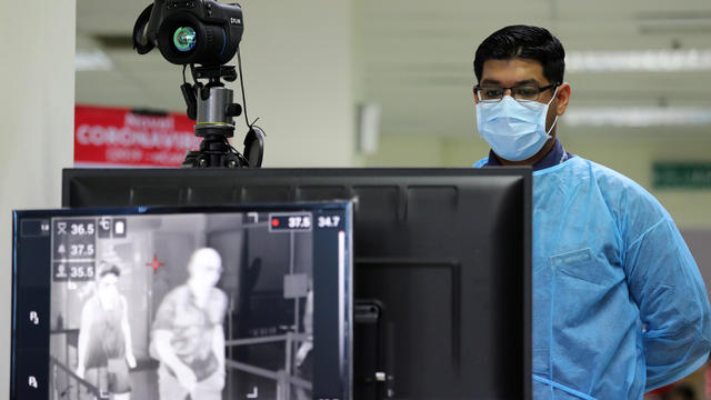 A Malaysian health quarantine officer waits for passengers at a thermal screening point at a cruise ship terminal, following the outbreak of the coronavirus in China, in Port Klang 