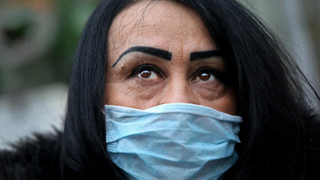 A woman wearing a face mask poses for a picture in New York City's Chinatown February 13, 2020. 