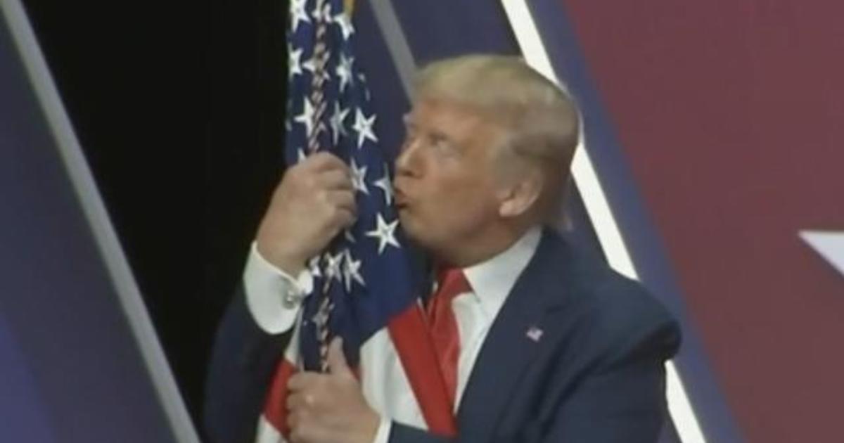 Trump hugs and kisses the American flag at CPAC 2020 - CBS News