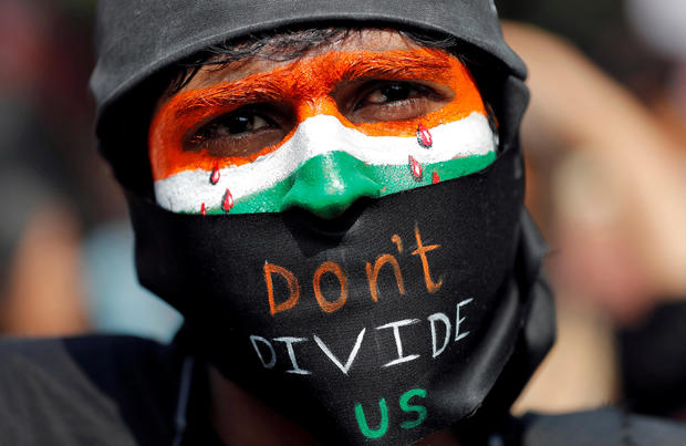 A demonstrator attends a protest against riots following clashes between people demonstrating for and against a new citizenship law in New Delhi 