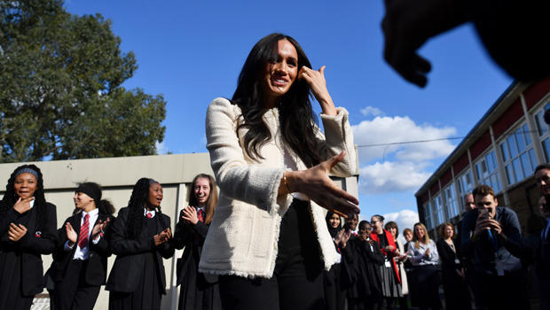 Britain's Meghan, Duchess of Sussex, smiles as she is welcomed by students to visit the Robert Clack School in Essex 
