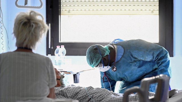 Medical worker wearing a protective mask, glasses and suit treats a patient suffering from coronavirus disease (COVID-19) in an intensive care unit at the Oglio Po hospital in Cremona 