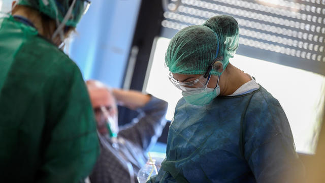 Medical staff wearing protective masks, glasses and suits treat patients suffering from coronavirus disease (COVID-19) in an intensive care unit at the Oglio Po hospital in Cremona 