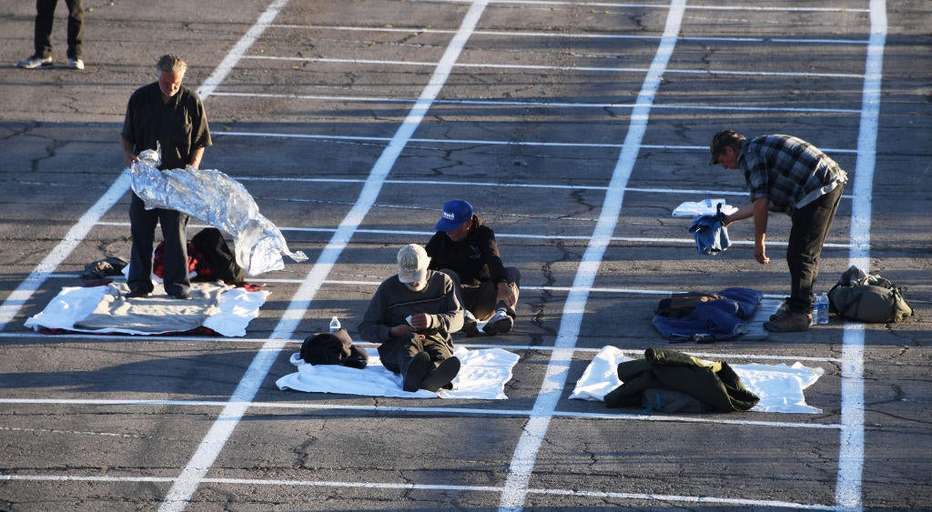 Photos of Las Vegas homeless sleeping in a parking lot after shelter