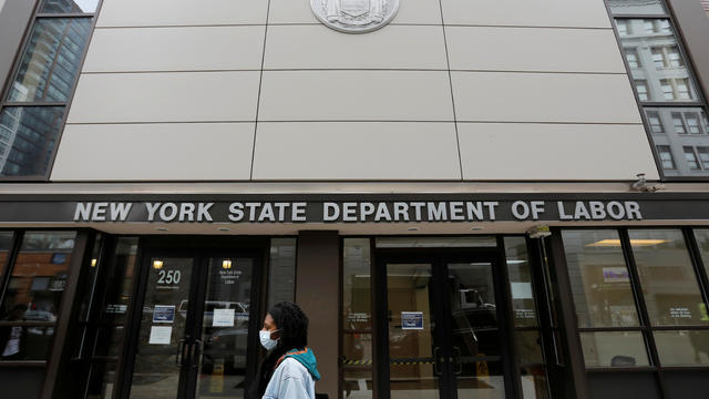 A person walks by the entrance of the New York State Department of Labor offices, which closed to the public due to the coronavirus disease (COVID-19) outbreak in the Brooklyn borough of New York City 