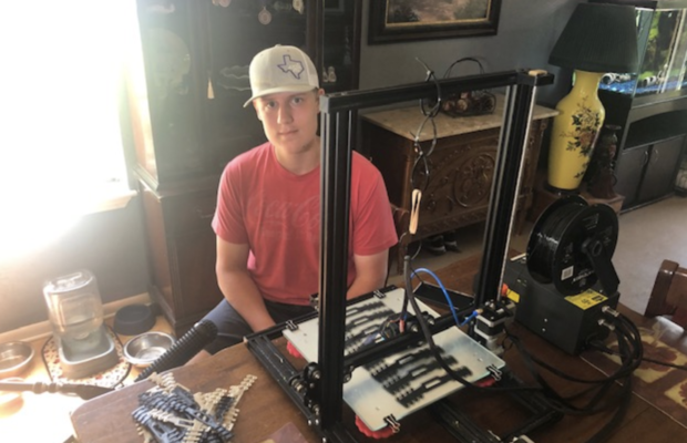 Noah McElwey uses a 3D printer to make "ear savers." 