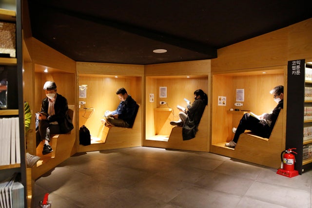 People wearing face masks to protect against contracting the coronavirus disease (COVID-19), sit a bookstore in central Seoul 