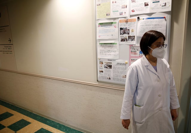 Fumie Sakamoto, a nurse of St. Luke's International Hospital stands in front of her office as she talks to Reuters reporters in Tokyo 