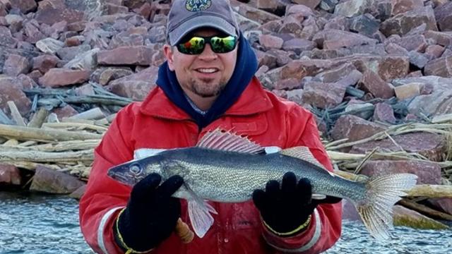 CPW-aquatic-biologist-Paul-Foutz-displays-a-walleye-caught-at-Lake-Pueblo-State-Park.-Photo-courtesy-CPW-Bill-Vogrin.jpg 