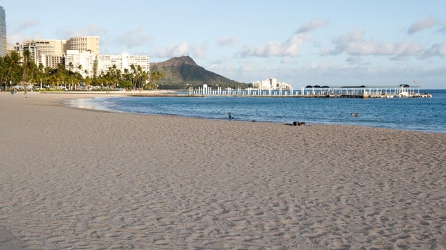 FILE PHOTO: Waikiki Beach is nearly empty due to the business downturn caused by the coronavirus disease (COVID-19) in Honolulu 