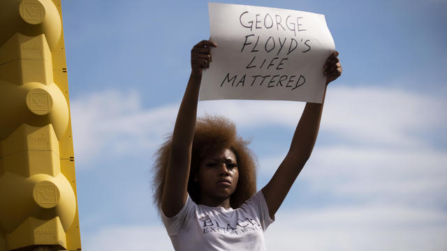 Protesters gather at the scene where Floyd was pinned down by a police officer in Minneapolis 